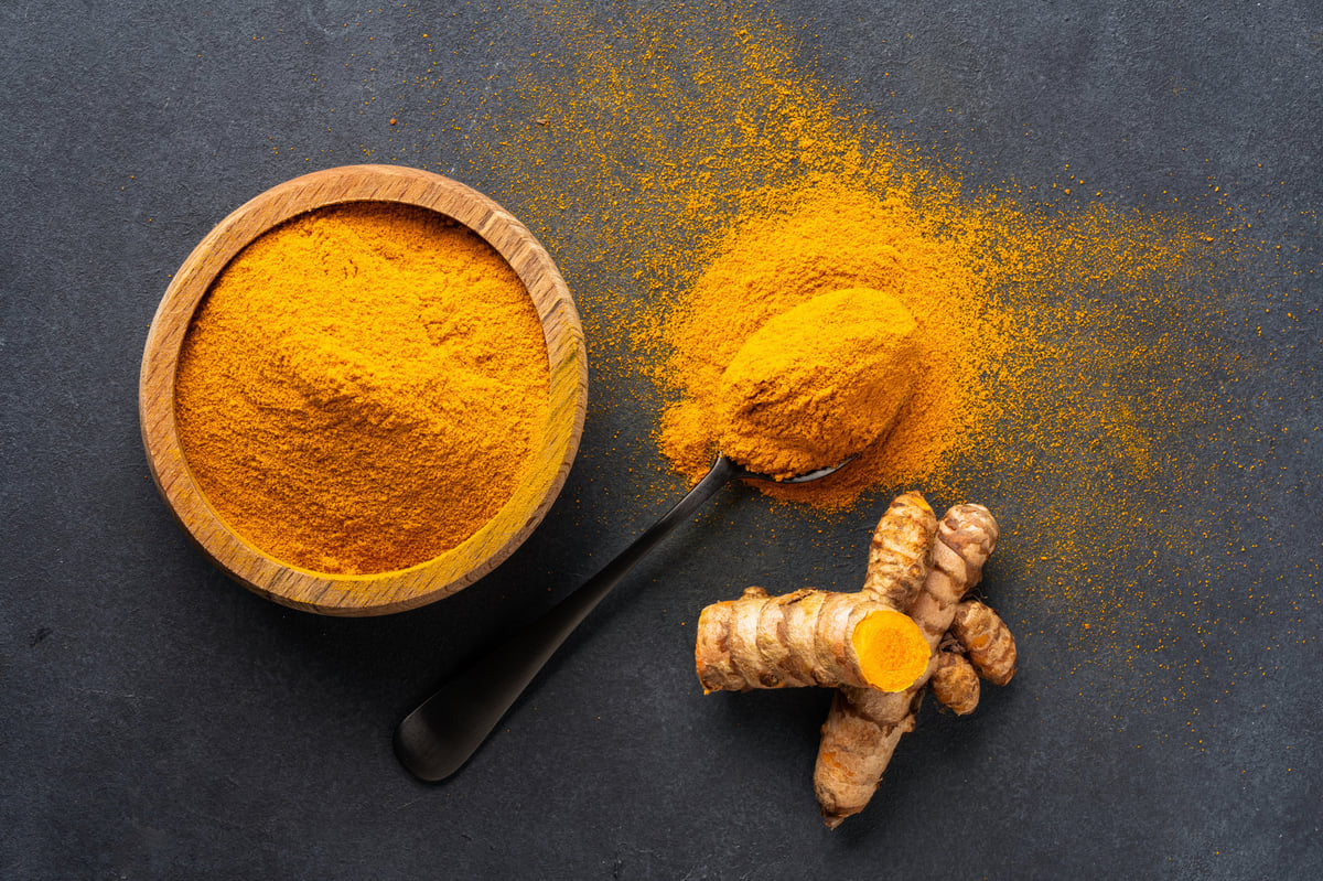 Turmeric root and powder in vivid orange